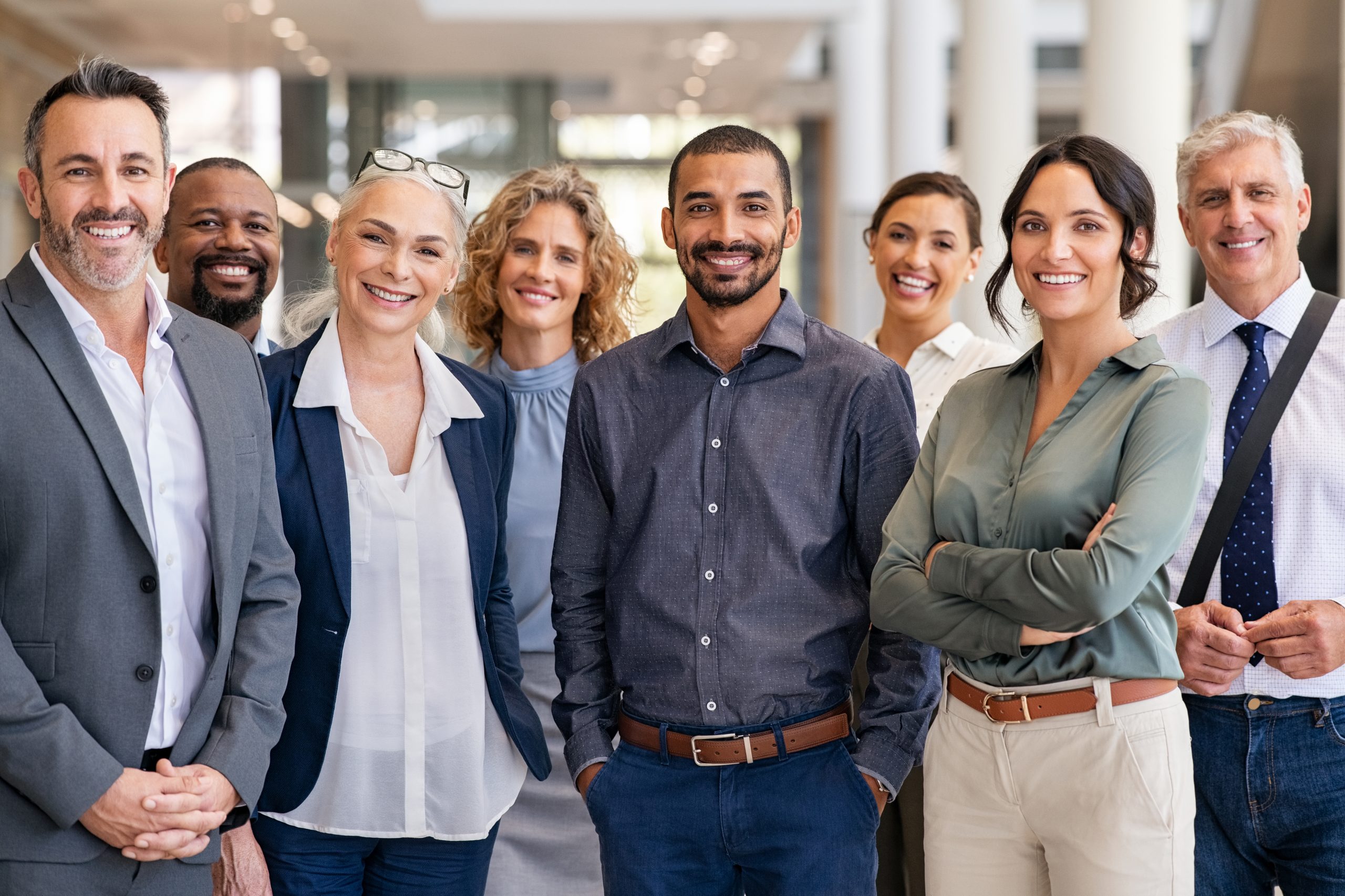 a group of employees smiling in a line